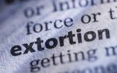 The word extortion in a dictionary. GettyImages/JLGutierrez