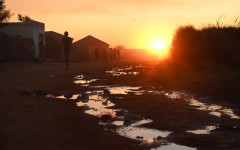 File: Puddles of sewage water on the side of a dirt road. Leon Sadiki/Bloomberg via Getty Images