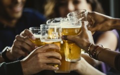 File: A group of friends toasting beer glasses. GettyImages/The Good Brigade