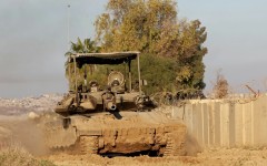 An Israeli tank drives into position near Israel's southern border with the Gaza Strip on January 14, 2025