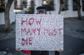 File: A woman protesting GBV. AFP/Marco Longari