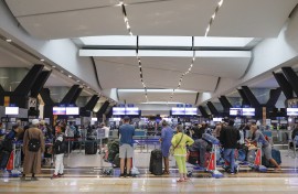 Travellers queue at a check-in counter at OR Tambo International Airport in Johannesburg.