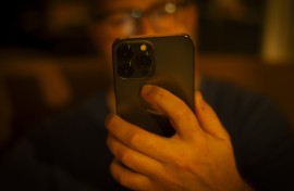 A man is seen using a mobile phone. 