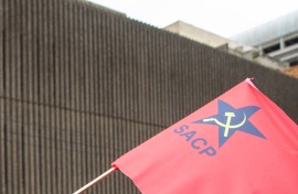 File: A flag displaying a logo of the South African Communist Party.