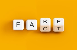 Fake news illustration, fake fact dice concept. Getty Images/Anton Melnyk