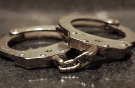 File: A pair of handcuffs on a table. Getty Images/James C Hooper