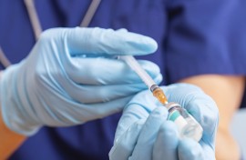 File: A healthcare worker fills a syringe with a vaccine. GettyImages/Andril Zorii