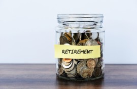 A bottle filled with coins for retirement. GettyImages/Nora Carol Photography