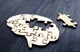 File: Brain from wooden puzzle pieces representing mental health and problems with memory. GettyImages/designer491