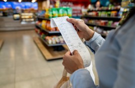 File: A shopper checking her receipt. GettyImages/Hispanolistic