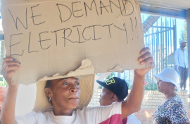 One of the protesters with a sign. eNCA/Hloni Mtimkulu