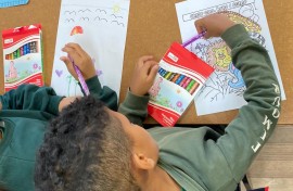 Back to school: A grade one pupil sits on his desk as schools reopen