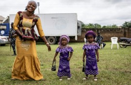 The twins paraded in immaculate matching outfits -- from glamorous sunglasses and patterned adire fabric to a pair of toddlers sporting purple dresses and identical handbags