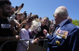 Britain's King Charles III chats with the owner of an alpaca named Hephner before leaving the Australian War Memorial in Canberra on October 21, 2024.