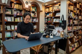 Rokurou Yui working at his bookstore in Tokyo