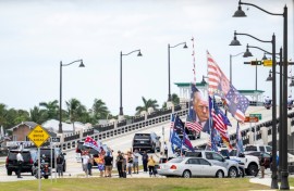 Supporters watch as the motorcade carrying US President-elect Donald Trump departs Mar-a-Lago in Palm Beach, Florida