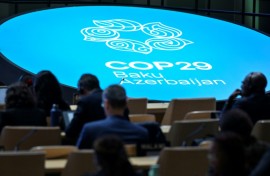 Delegates listen to speeches at COP29 in Baku