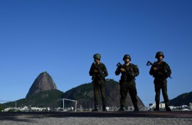 Brazilian army soldiers stand guard on Botafogo beach with the Sugar Loaf mountain in the background during the G20 Summit in Rio de Janeiro