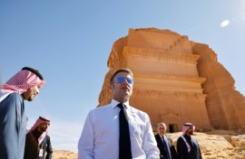 A world away from the crisis, French President Emmanuel Macron strolled through the desert sands of the Al-Ula oasis on a state visit to Saudi Arabia, marvelling at ancient landmarks