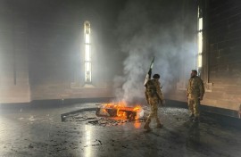 Rebel fighters set fire to the tomb of Assad's father and predecessor Hafez in their home village of Qardaha