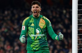 Manchester United goalkeeper Altay Bayindir celebrates after saving Kai Havertz's penalty