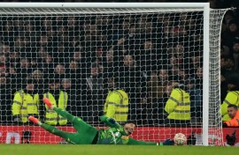 Man of the moment: Manchester United goalkeeper Altay Bayindir saves the penalty of Kai Havertz in the shootout