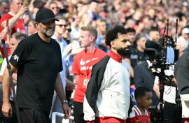 Jurgen Klopp walks out with Mohamed Salah before the German's final match in charge of Liverpool last May