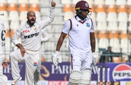 Pakistan's Sajid Khan celebrates after taking the wicket of West Indies' Keacy Carty (R) during the second day of the first Test at Multan