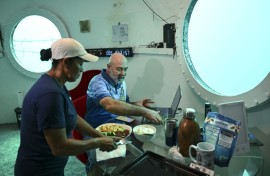 Rudiger Koch has breakfast in his underwater home before emerging as a world record holder