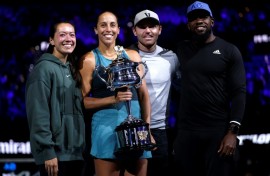 Madison Keys stands alongside husband and coach Bjorn Fratangelo with her team after lifting the Australian Open trophy