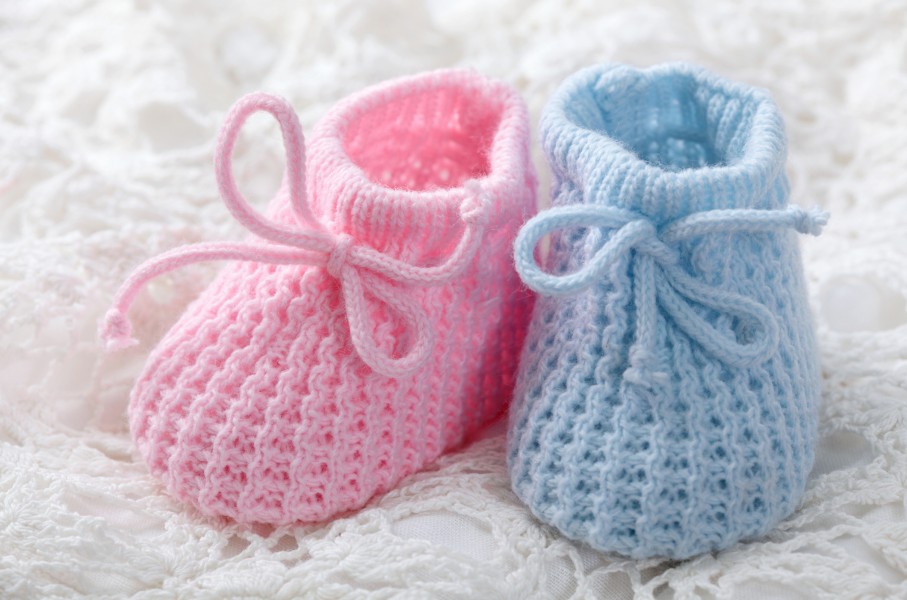 File: Blue and pink baby booties. GettyImages/egal