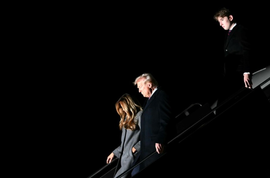 US President-elect Donald Trump, his wife Melania and son Barron arrive at Dulles International Airport in Virginia on January 18, 2025