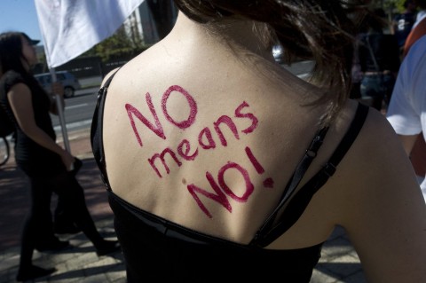 File: "No means No " is written on the back of a woman. AFP/STR