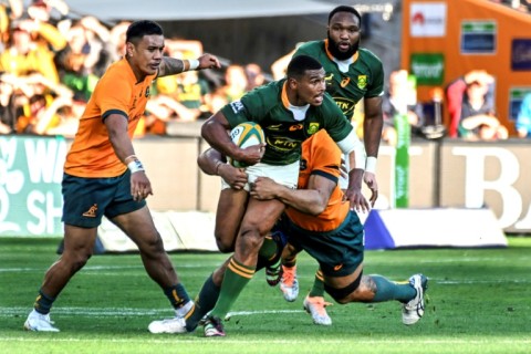 South Africa's Damian Willemse tries to ride an Australian tackle