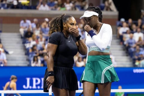 Serena Williams (left) and Venus Williams were beaten in the opening round of the women's doubles at the US Open on Thursday