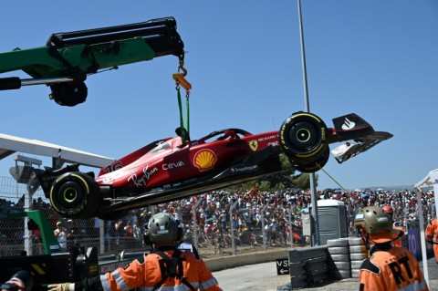 Charles Leclerc's car is removed from the barriers after he crashed at the French Grand Prix in July