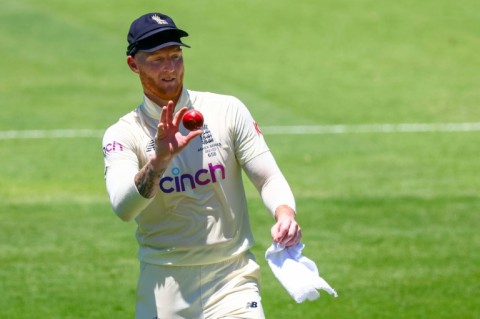 England's Ben Stokes shines the ball -- without using saliva, which has been banned permanently