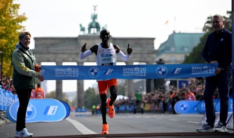 Kenya's Eliud Kipchoge crossing the line with a new world marathon record 