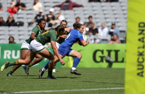 France's Laure Sansus runs the ball during their opening win