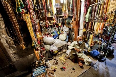 A vendor sits outside his shop in Souq Waqif: crowds are already growing as a World Cup buzz mounts