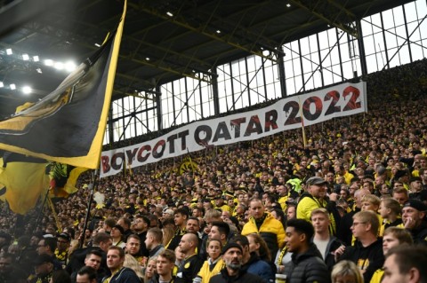 Dortmund fans in the club's famous 'yellow wall' hold up a banner reading "#Boycott Qatar 2022" 