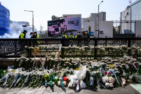 Flower tributes are seen at a makeshift memorial outside a subway station in Seoul's Itaewon district, two days after a deadly Halloween surge in the area