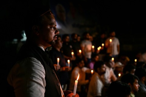 Members of India's Youth Congress take part in a candlelight vigil in New Delhi on Monday for victims of the bridge collapse