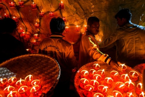 Revellers prepare lanterns to attach to hot-air balloons during the Tazaungdaing festival in Pyin Oo Lwin, Myanmar