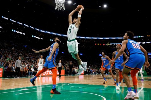 Boston's Jayson Tatum goes in for a slam dunk over Oklahoma City's Kenrich Williams in the Celtics' 126-122 NBA victory