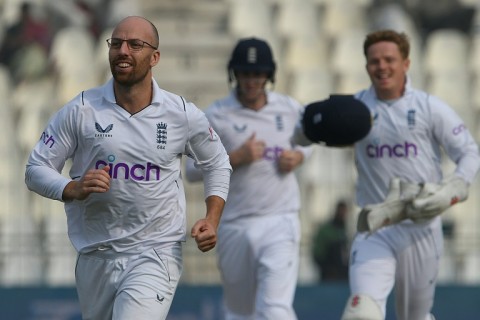 England's Jack Leach (L) celebrates the dismissal of Pakistan's Saud Shakeel, his 100th Test wicket