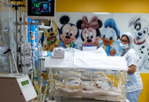 A Moroccan health worker keeps an eye on one of the nine babies after their birth in Casablanca last year