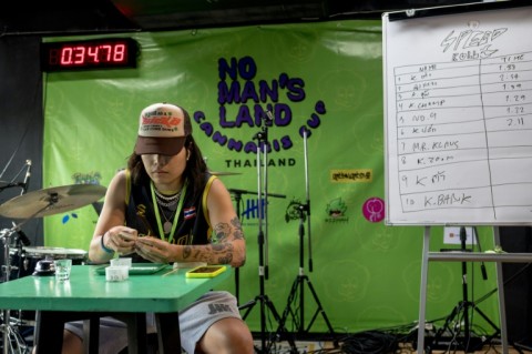 A contestant takes part in the speed rolling competition at the Cannabis Cup in Bangkok