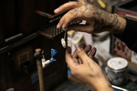 Danny Cortes puts some touches to one of his hip-hop-inspired miniatures in his New York workshop