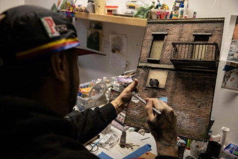 The 42-year-old Danny Cortes adds meticulous detail to one of his miniature New York street scenes